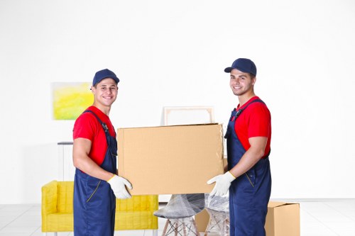 Moving team using safe handling practices during a house removal
