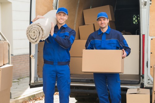 Packed boxes and apartment hallway access during a Shepherds Bush removal