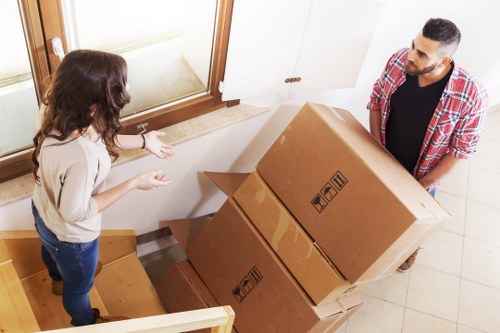 Packed moving boxes and furniture ready for transport in West London