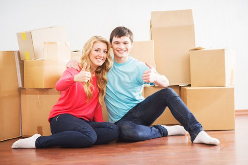 Trained movers handling boxes safely inside a residential property